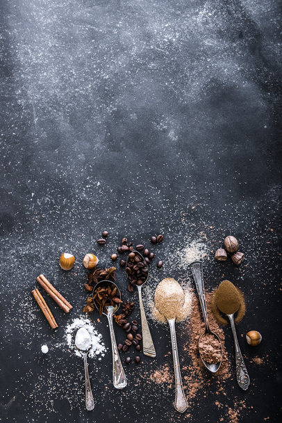 Sweet spices in the spoons on the table - Photo, Image