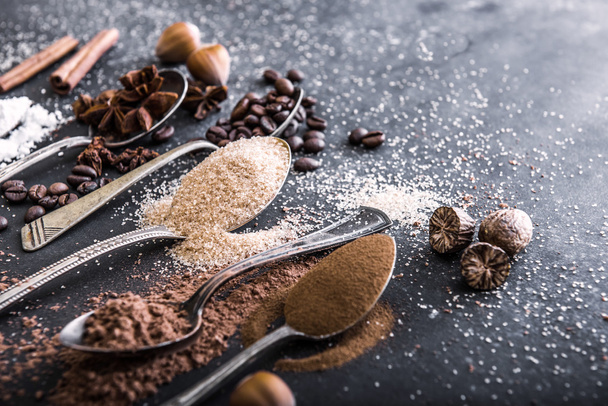 Chocolate powder cocoa and coffee spoons on the table - Фото, изображение