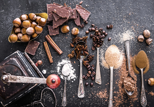 Sweet spices  and chocolate on a table  - Фото, изображение