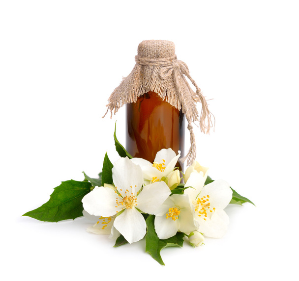 Flowers of a jasmine and pharmaceutical bottle.  - Foto, afbeelding