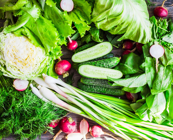 collection of raw green vegetables on rustic background, vegan - Fotó, kép
