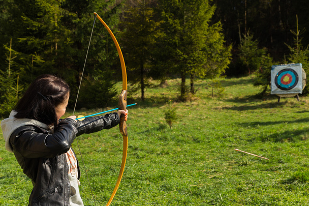 Father and son engaged in archery - 写真・画像