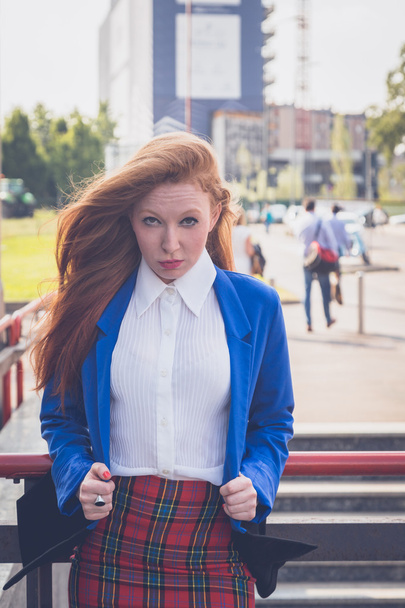 Beautiful redhead girl posing in an urban context - Foto, imagen