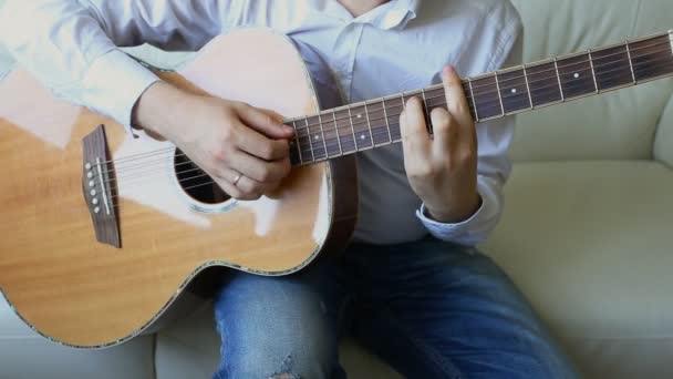 Practicing in playing guitar. Handsome young men playing guitar - Metraje, vídeo