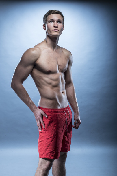 Male fitness model wearing red shorts - Fotografie, Obrázek