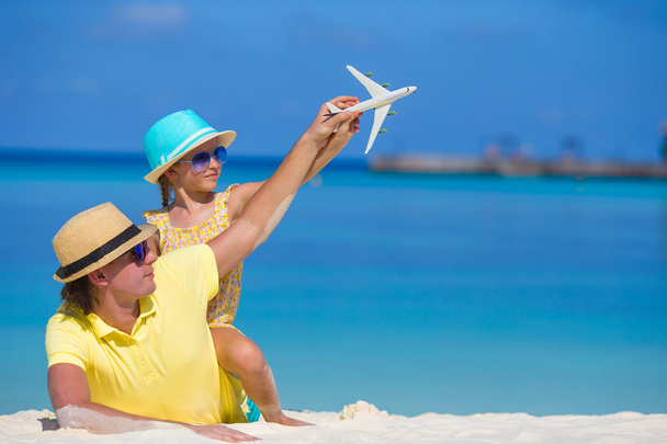 Jeune homme et petite fille avec miniature d'avion à la plage
 - Photo, image