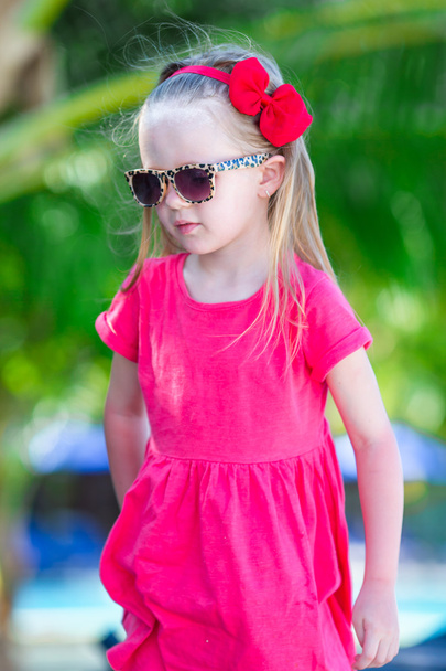 Portrait of beautiful little girl outdoor at tropical resort - Photo, Image