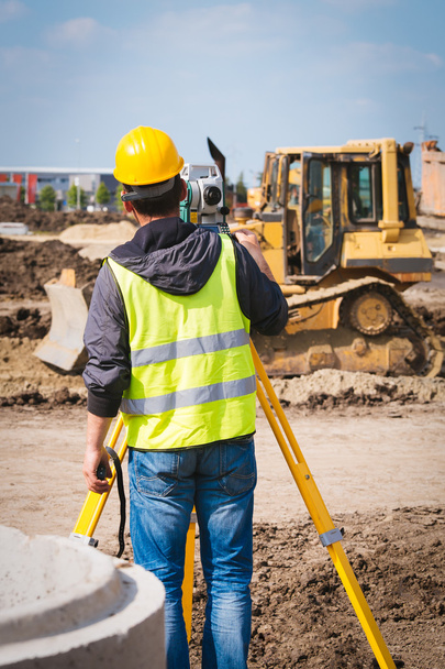 Surveyor engineer worker making measuring with theodolite tool equipment at construction site - Photo, Image
