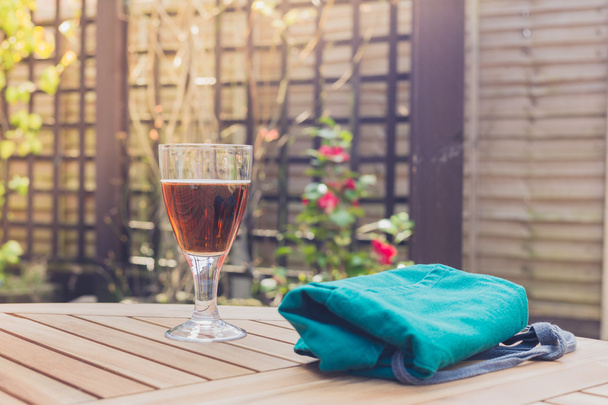 Glass of beer and apron on table - Фото, изображение