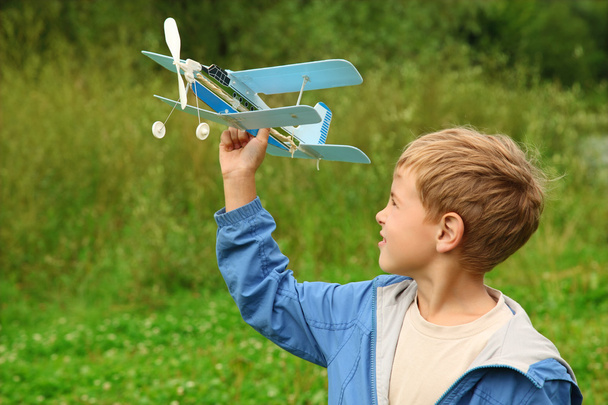 Boy with toy airplane in hands outdoor - Valokuva, kuva