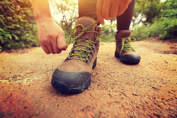 Woman hiker tying shoelace - Fotoğraf, Görsel