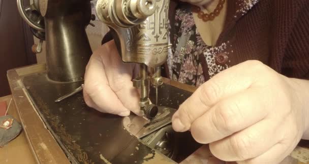 grandmother sews a red flag on an old sewing machine of the Soviet Union retro, See the entire collection - many super close-ups, RAW format for color correction - Footage, Video