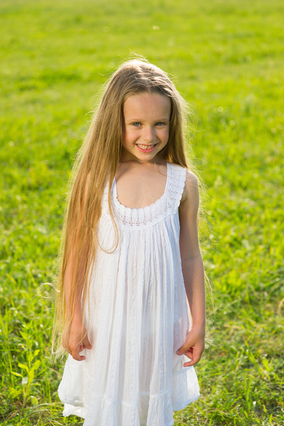  Small girl on the lawn. - Фото, зображення