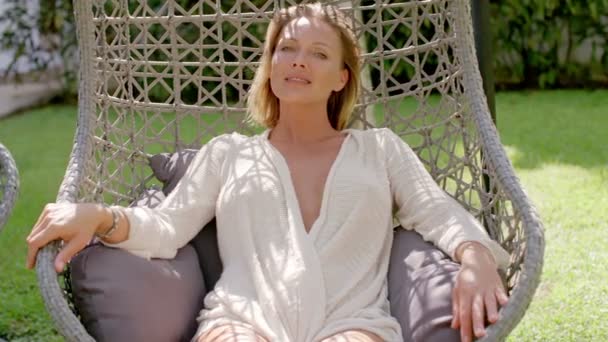 Woman Relaxing in Outdoor Hanging Chair - Footage, Video
