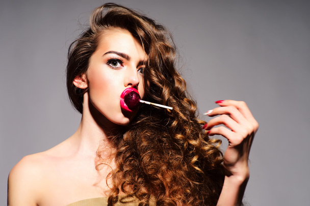 Taking playful young woman with lollipop  - Φωτογραφία, εικόνα