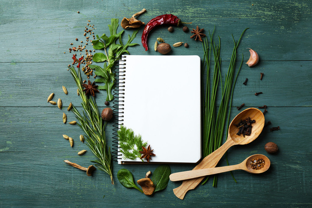 recipe book with fresh herbs and spices - 写真・画像