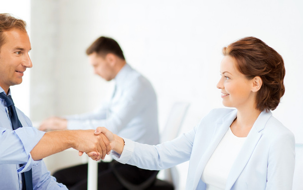 man and woman shaking hands in office - Foto, immagini