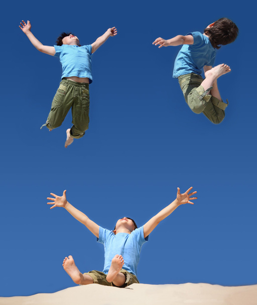 Jumping boys on blue sky, sitting boy with hands and legs up on - Fotografie, Obrázek