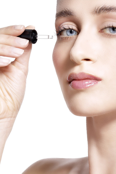 beautiful model applying a skin serum treatment  - Photo, Image