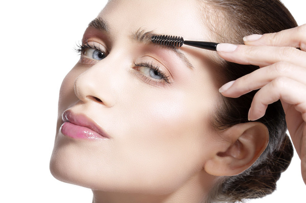 Closeup beautiful woman with eyebrow brush tool  - Фото, зображення
