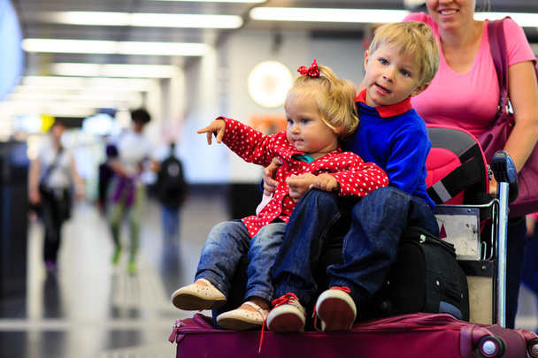 little boy and toddler girl travel in the airport - Fotó, kép