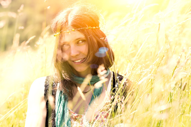 Hippie girl in the meadow in a photograph with vintage artifacts - Photo, Image