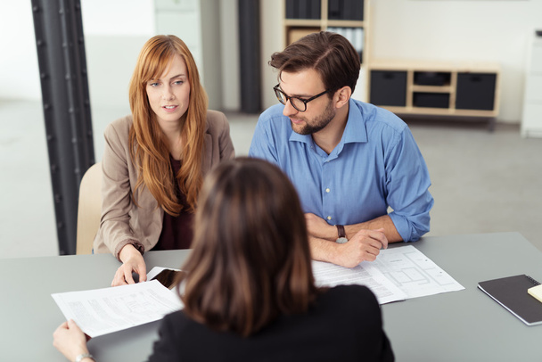 Young couple discussing investments with a broker - Foto, Imagem