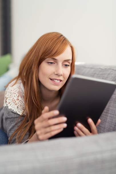 Woman Relaxing on Sofa with Computer Tablet - Foto, immagini