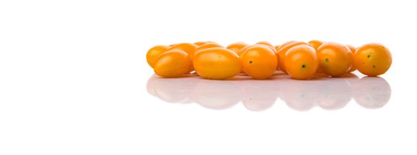 Yellow orange grape tomato over white background - Photo, image
