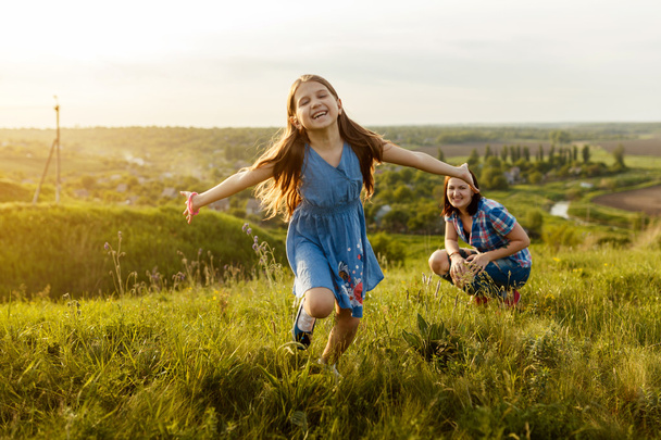 Little girl running on meadow - Photo, Image