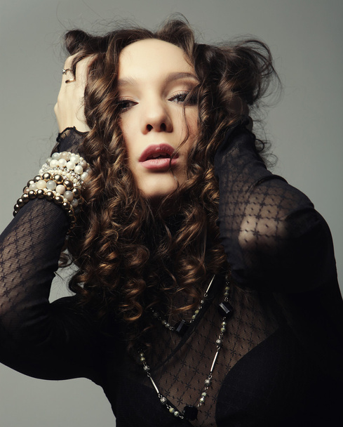 Young fashion model with curly hair - Valokuva, kuva