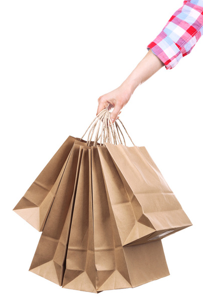 Female hand holding paper shopping bag isolated on white - Foto, afbeelding