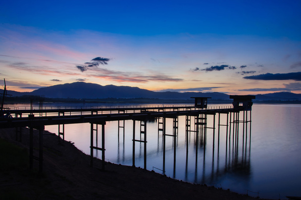 old bridge at the lake with sunrise. - Photo, Image