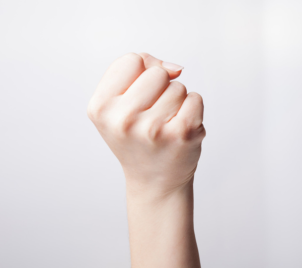 Hand clenched in front of the camera over white background - Foto, immagini