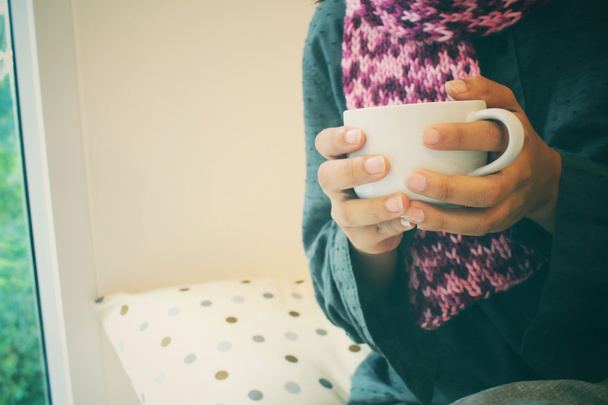Woman drinking coffee sitting in bed  - Valokuva, kuva