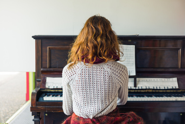 Young woman playing the piano - Fotó, kép