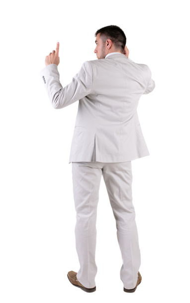 Back view of thinking young business man in white suit. - Valokuva, kuva