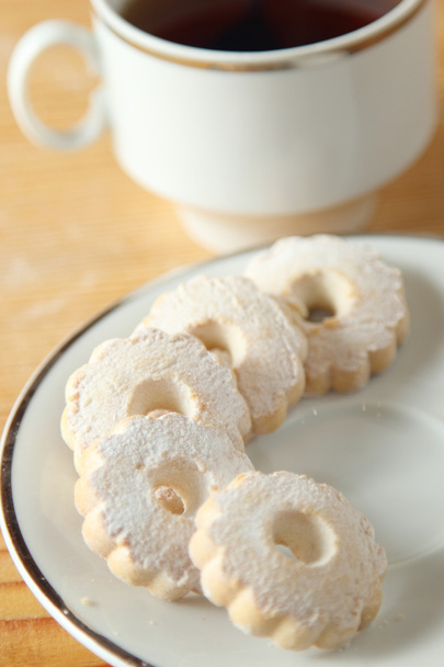 Italian Canestrelli biscuits on the saucer near a cup of black tea - Photo, Image