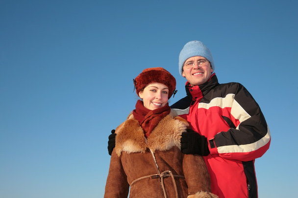 Couple against blue sky background in winter 2 - Zdjęcie, obraz