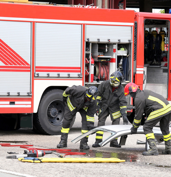 firefighters during a road accident with car parts - Photo, Image