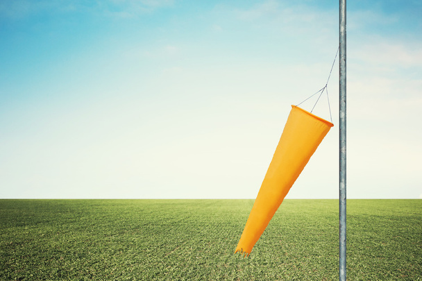 Calm windsock indicates no wind in a golf field - Photo, Image
