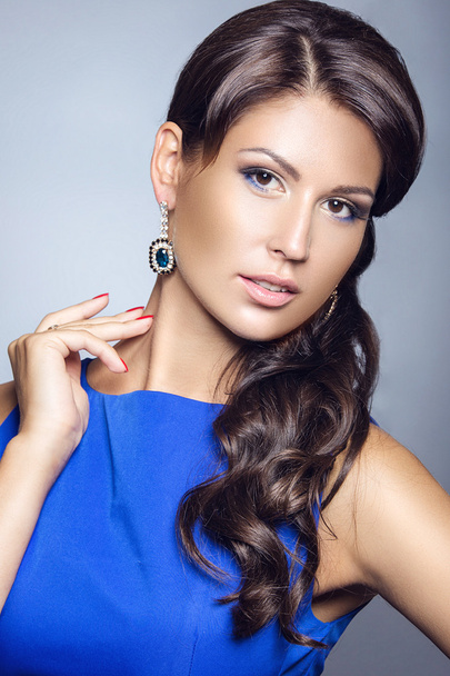 Beautiful brunette girl in a blue dress with evening make-up and perfect skin. Beauty face. - Fotoğraf, Görsel