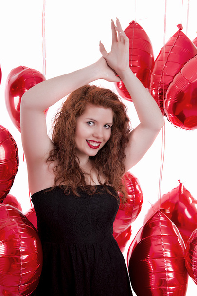happy young girl between red balloons - Фото, изображение