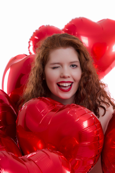 happy young girl between red balloons - Φωτογραφία, εικόνα