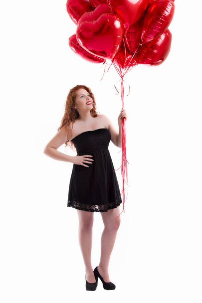 happy young girl holding a red balloon - Foto, imagen