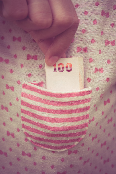 Taking money from  pocket with filter effect retro vintage style - Φωτογραφία, εικόνα