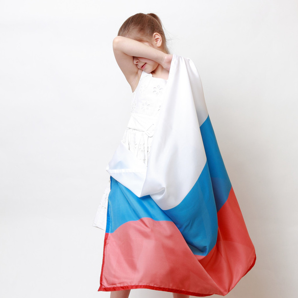 Kid holding symbolic flag - 写真・画像