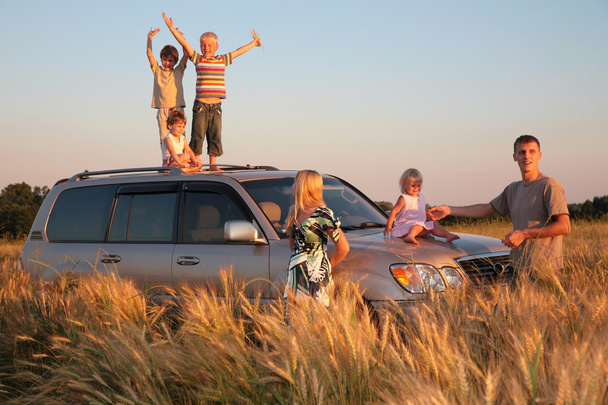 Parents and children on offroad car on wheaten field - Fotoğraf, Görsel