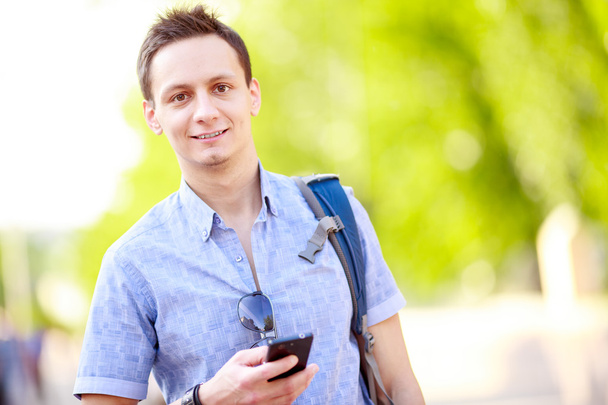 Close up portrait of a young man with phone - Photo, Image
