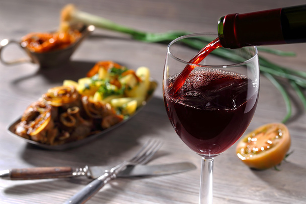 Pouring red wine and food - Foto, imagen